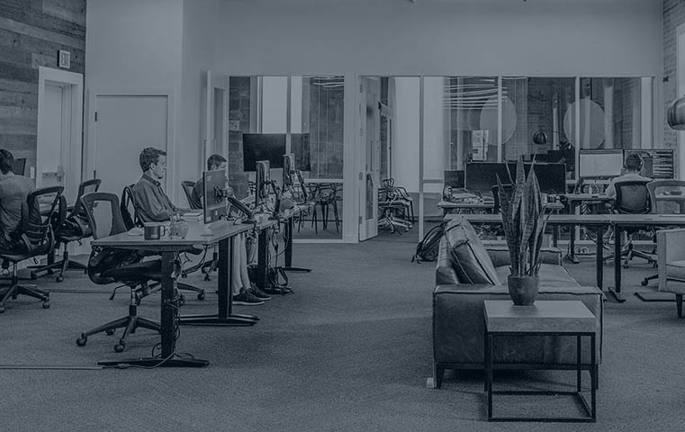 black and white image of people working in an office